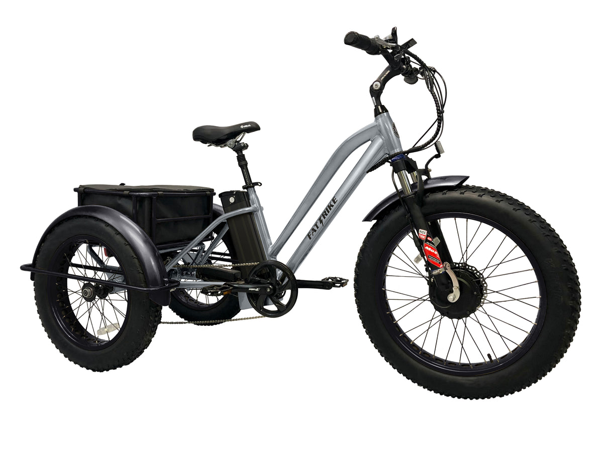 The Silver electric Fat Trike with 3 black fenders, and a drybag in the rear basket